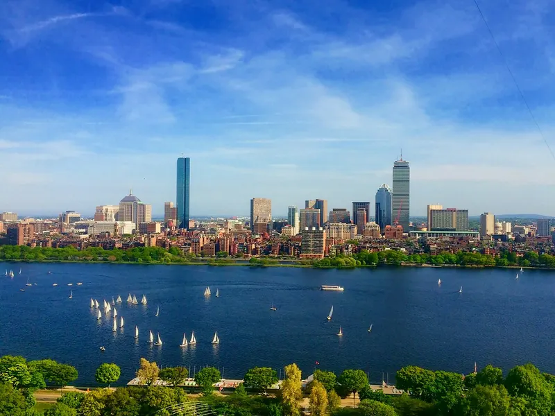 Boston skyline across the Charles River with sailboats on the water