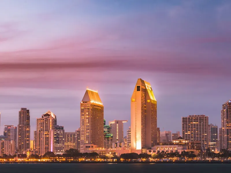 San Diego waterfront skyline at dusk under a pink sky